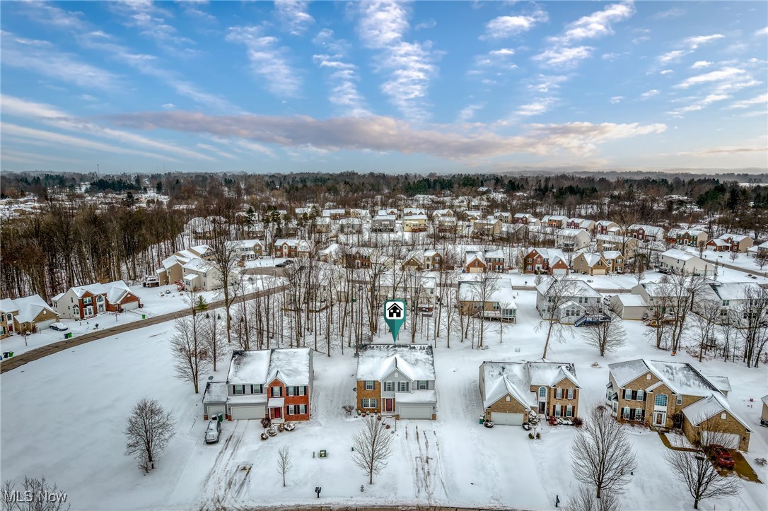 Aerial view of snow-covered homes in a Bedford subdivision, with the listed house marked near center.