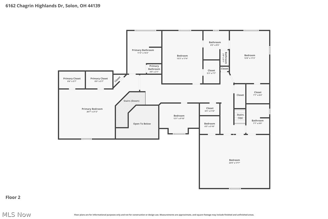 Second-floor plan showing the primary suite, multiple bedrooms, bathrooms, stairs, and an open-to-below area.