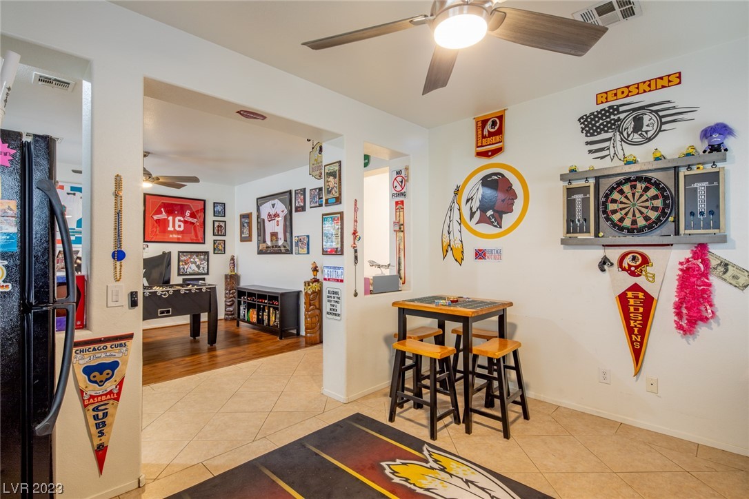 Sports-themed game room with a dartboard, high-top table, and Redskins and Cubs memorabilia.