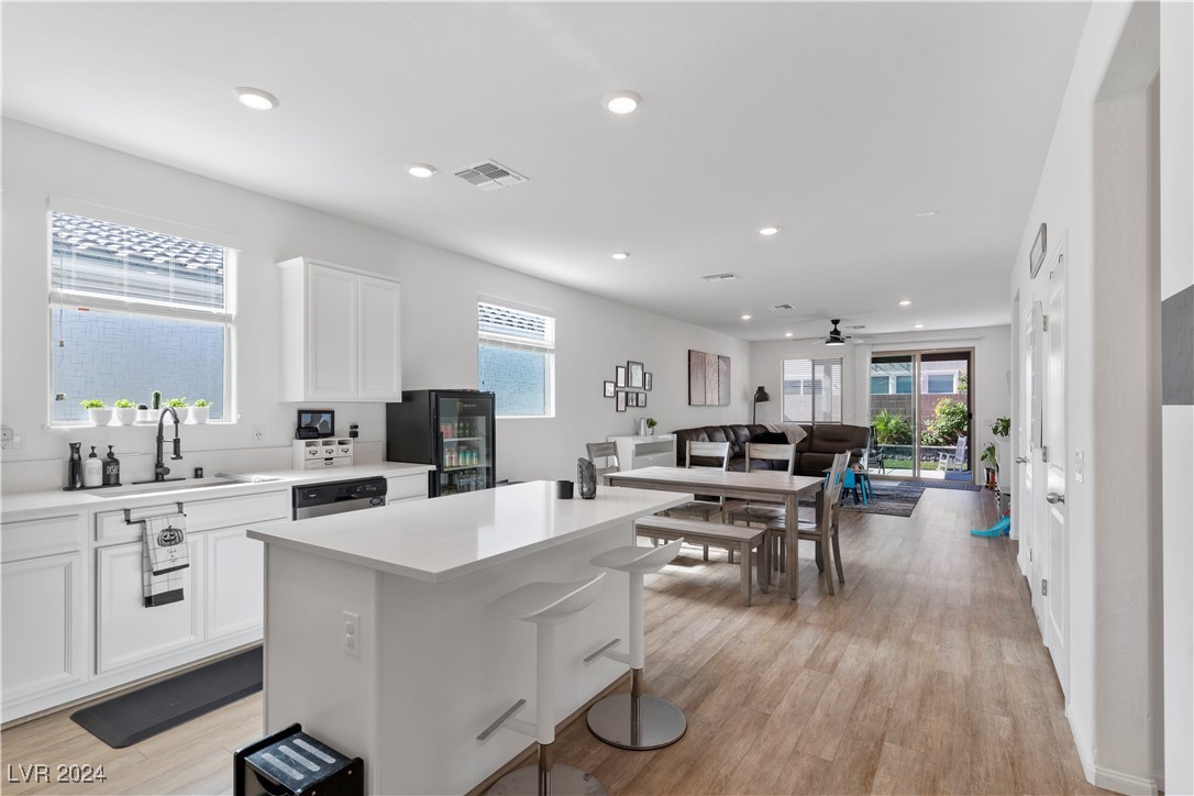 Open-plan kitchen and living area with a large white island and sliding glass doors to the patio.