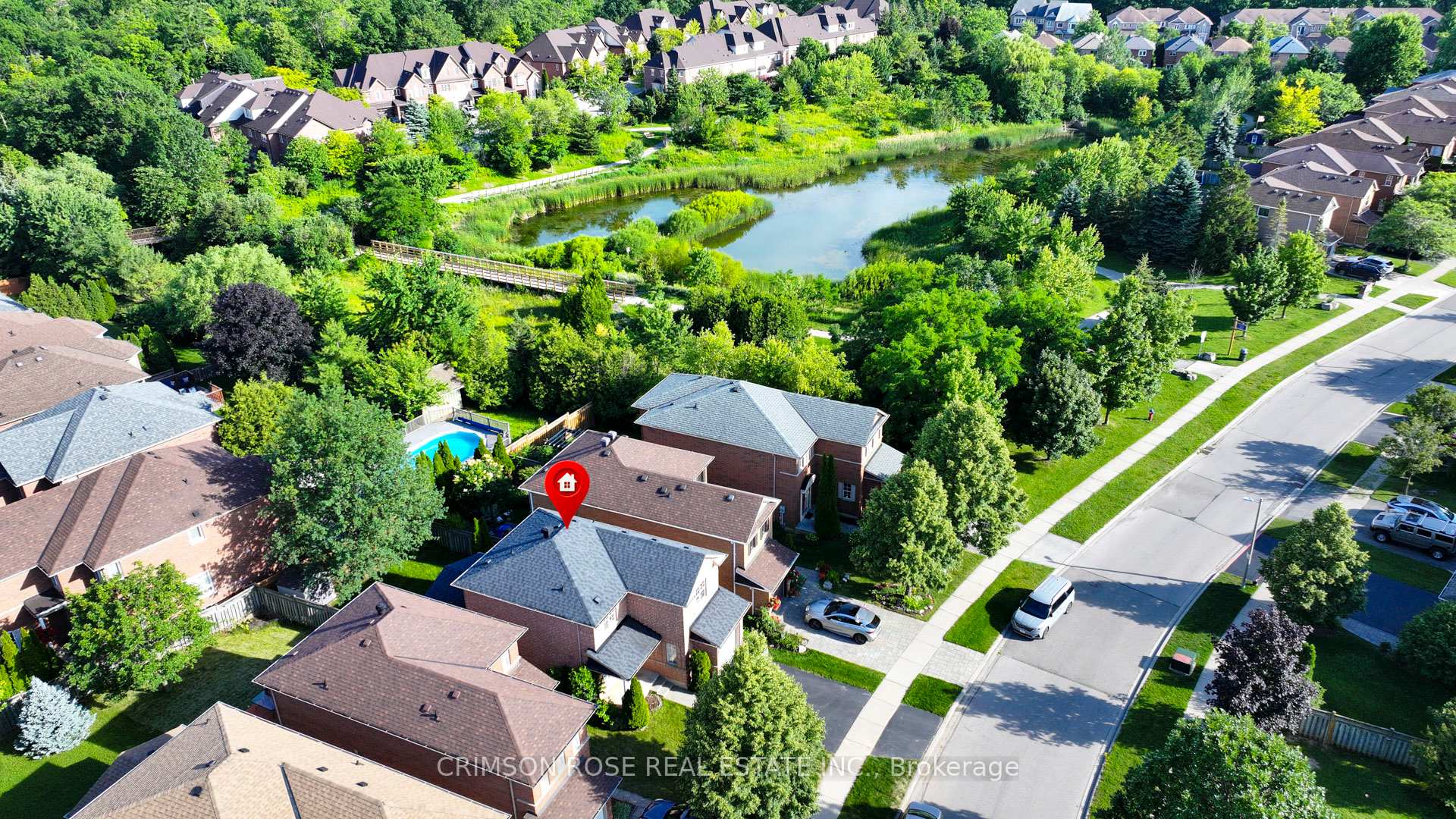 Aerial view of 506 Pondview Place beside a pond and footbridge, with the home marked by a red pin.