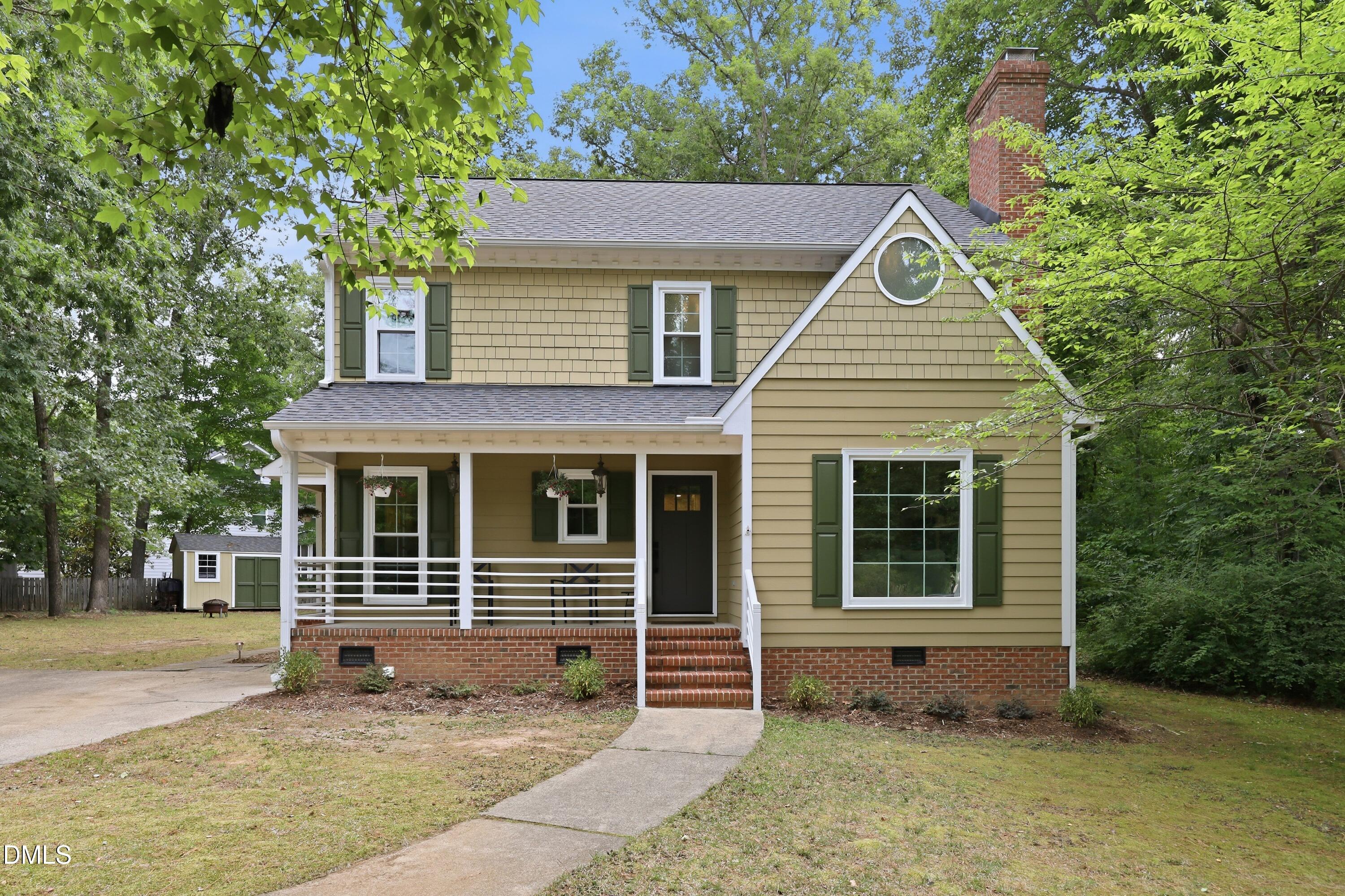 Front exterior of 1004 Lantern Light Court, a remodeled home in Apex, NC featuring updated finishes, mature landscaping, and a private wooded homesite.