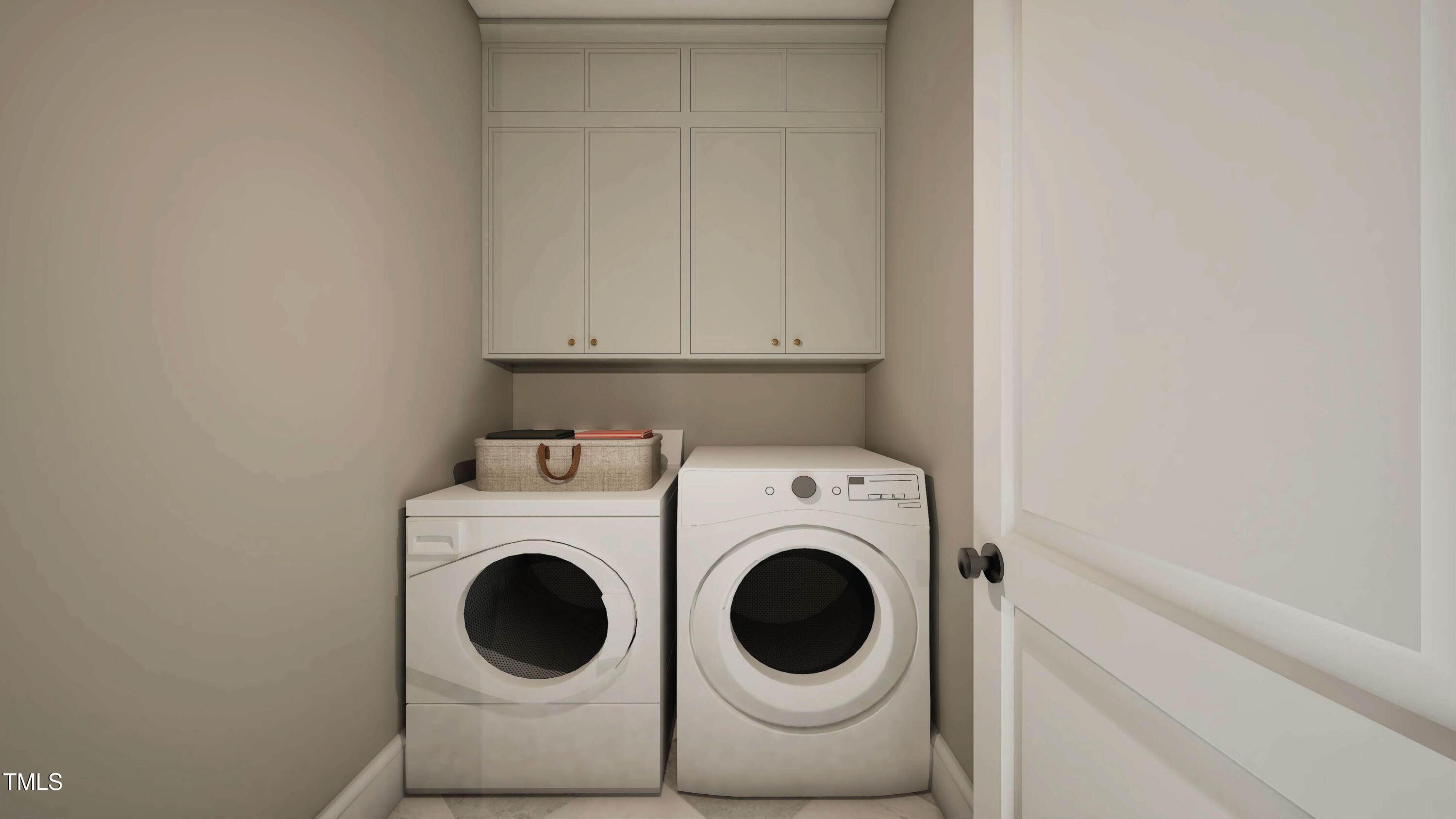 Laundry room with white washer and dryer beneath built-in cabinets.