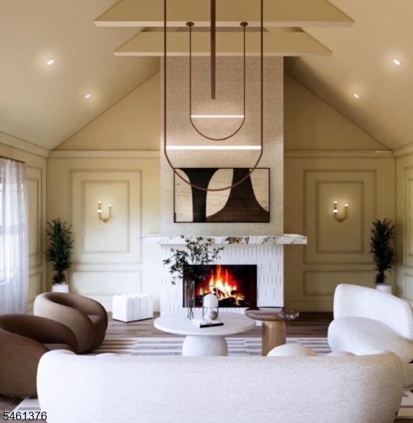 Living room with a vaulted ceiling, suspended light, and fireplace between curved seating.