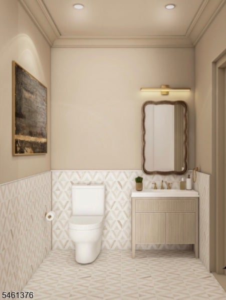 Powder room with a white toilet, geometric tile, and a light wood vanity beneath a framed mirror.