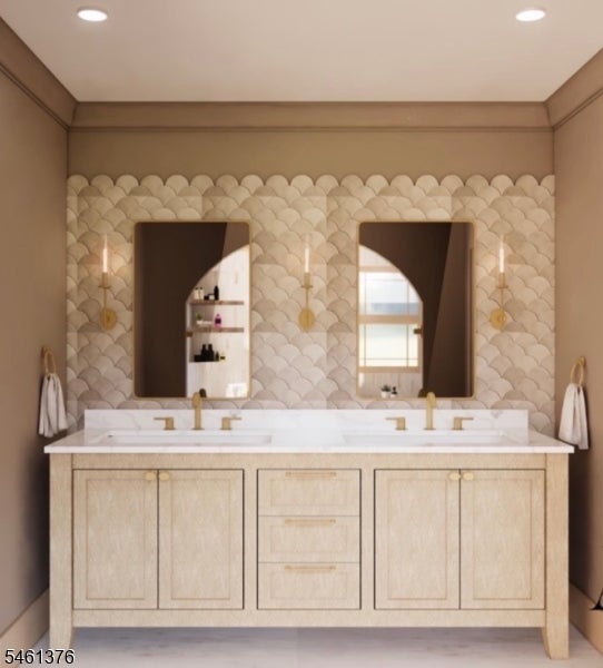 Bathroom with a double vanity, paired mirrors, brass fixtures, and scallop-patterned tile.