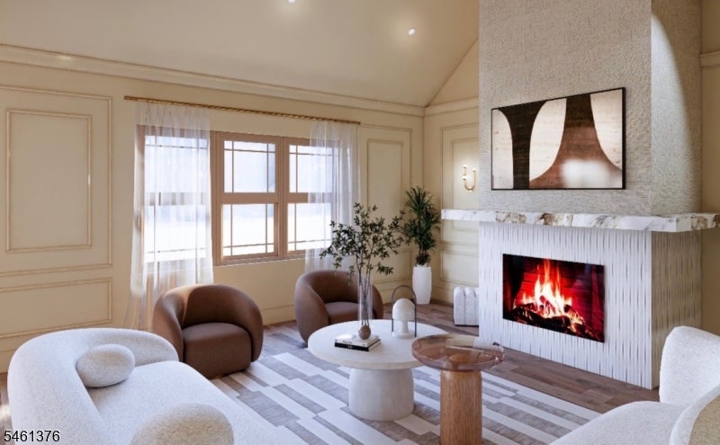 Staged living room with a white fireplace, abstract artwork, and rounded brown lounge chairs.