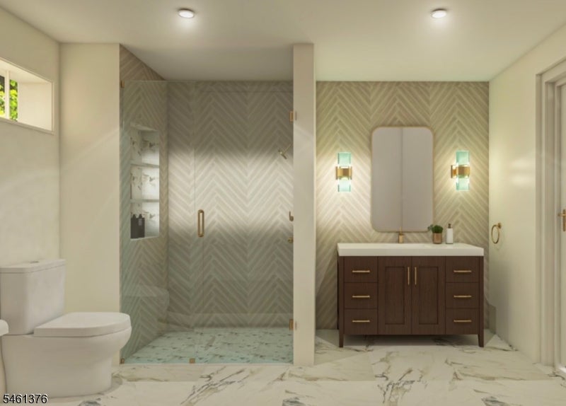 Bathroom with a glass-enclosed shower, herringbone tile walls, and dark wood vanity.