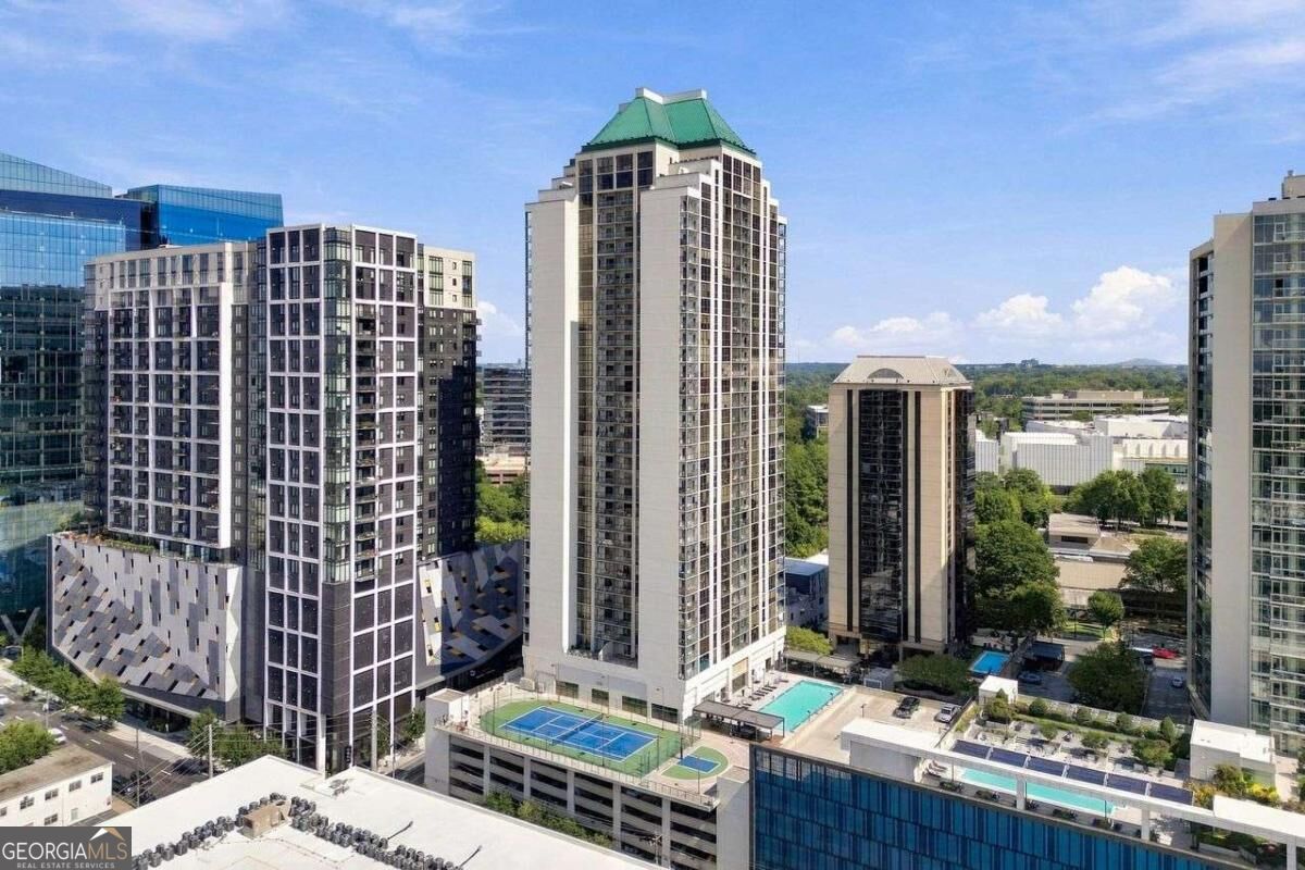 Atlanta high-rise skyline with a green-roofed tower, rooftop pools, and tennis courts.