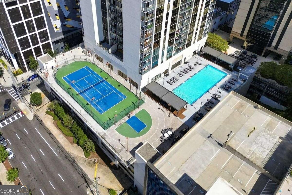 Condominium amenities with a rooftop pool, tennis court, and basketball court.