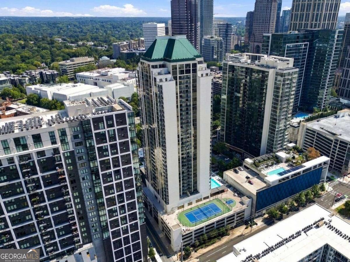 Aerial view of Atlanta high-rises, with rooftop sports courts and a pool among the surrounding skyline.
