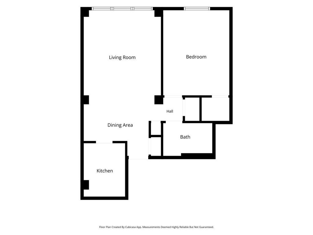Floor plan showing a living room, bedroom, dining area, kitchen, hall, and bath.