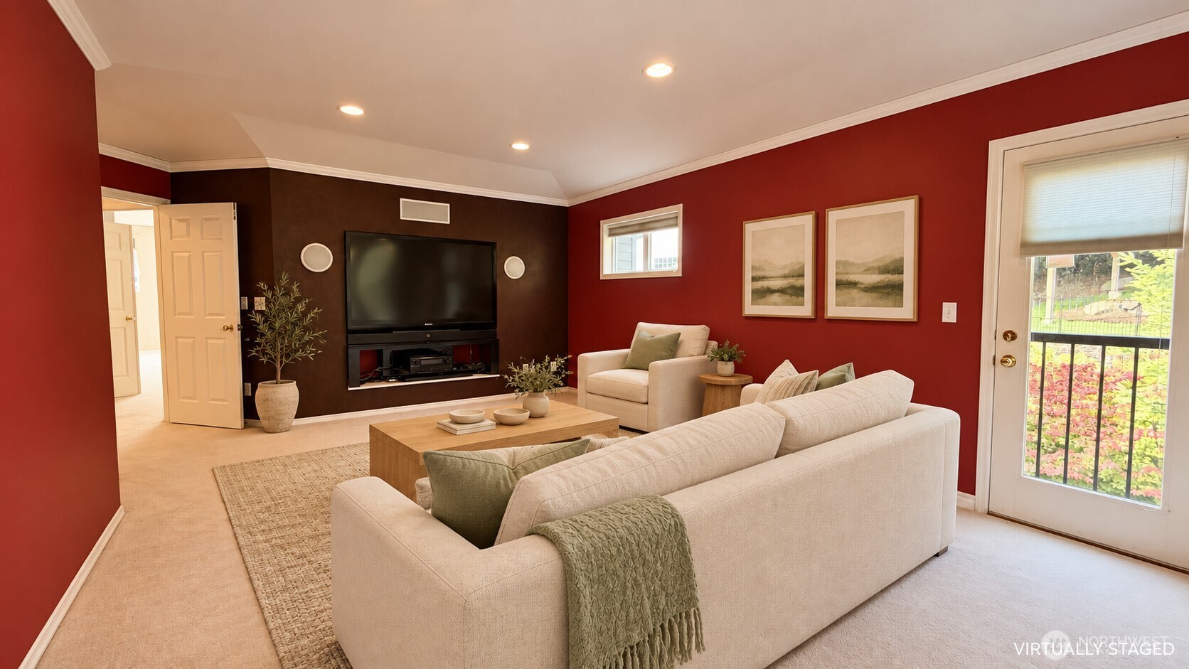 Staged living room with cream sofas, red walls, and a built-in entertainment center.