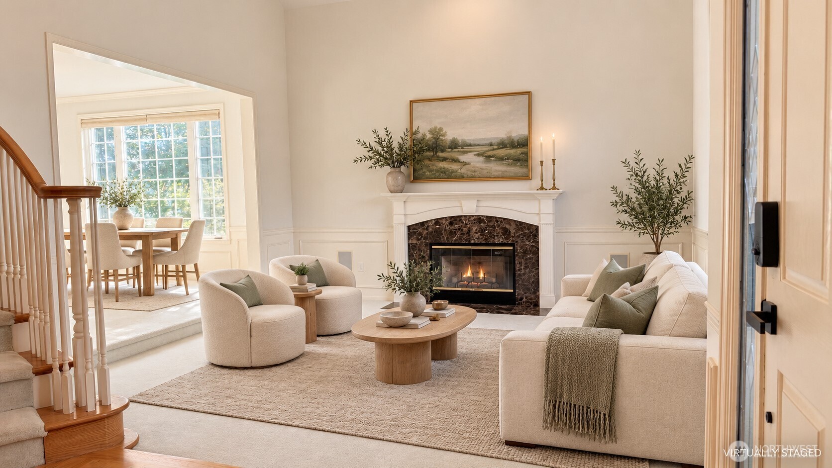 Staged living room with marble fireplace, cream seating, and adjoining sunlit dining area.