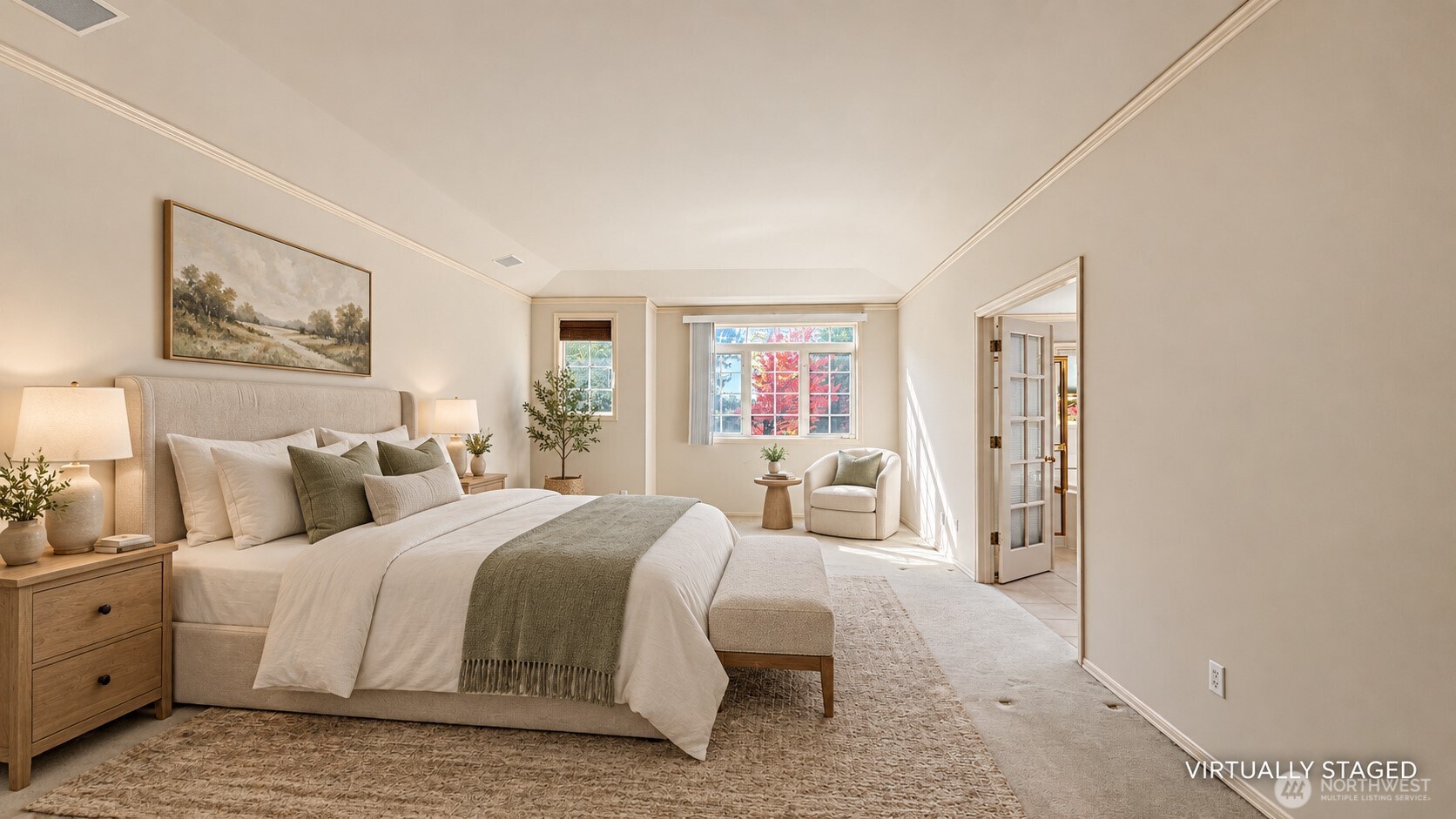 Virtually staged bedroom with a large neutral bed, cushioned bench, and bright window overlooking red foliage.