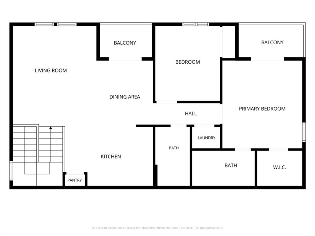 Floor plan with two bedrooms, two balconies, two bathrooms, kitchen, and living and dining areas.