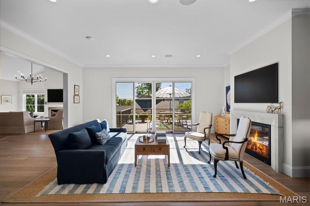 Furnished living room with blue sofa, striped rug, fireplace, and sliding doors to a patio.