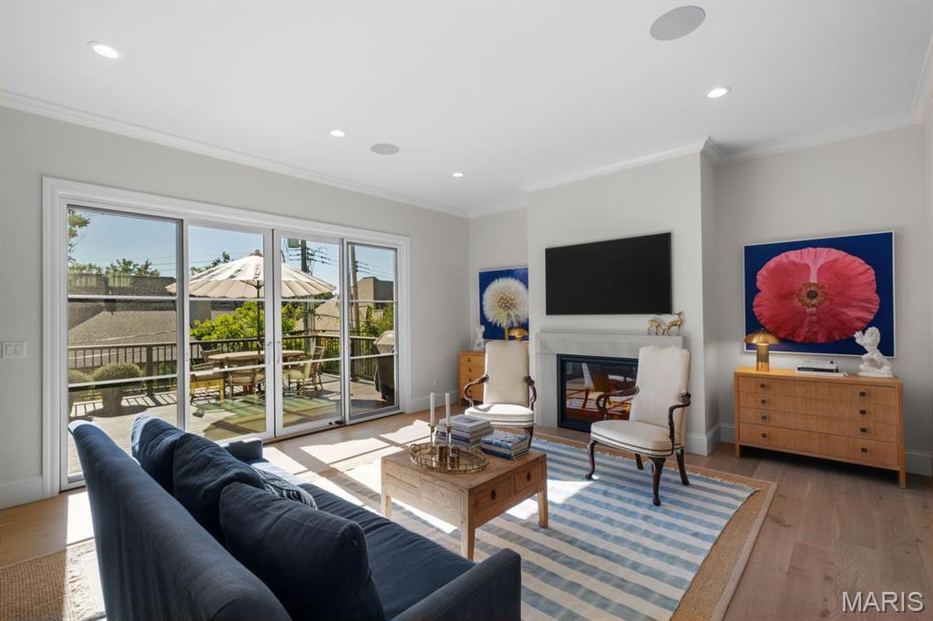 Living room with a fireplace, dark blue sofa, and sliding glass doors to a sunny deck.