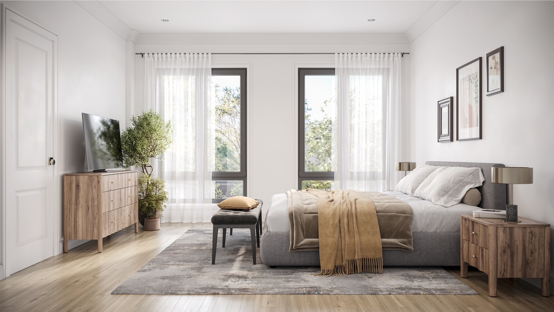 Staged bedroom with a gray bed, wood furnishings, and tall windows with sheer curtains.
