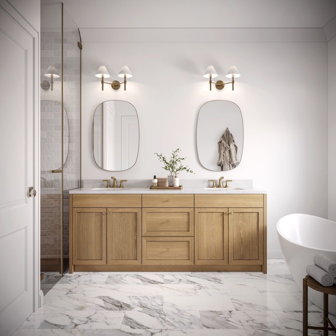 Bathroom with a double oak vanity, paired oval mirrors, glass shower, and freestanding tub.