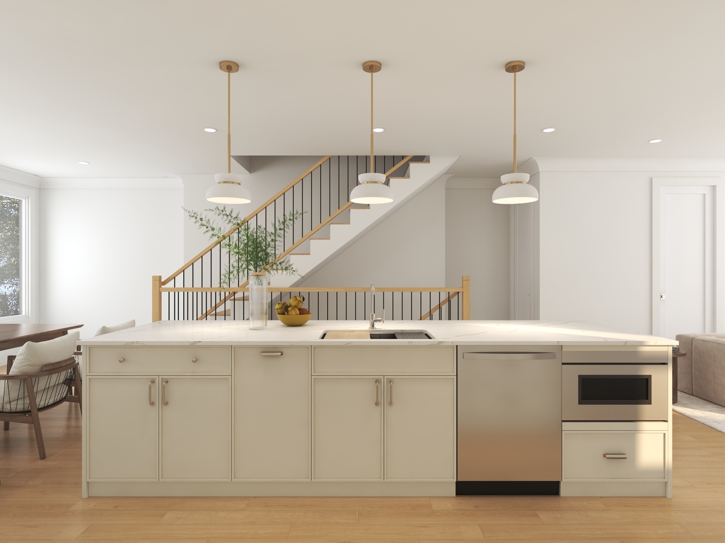 Open-plan kitchen with a large island, built-in oven, and staircase behind it.