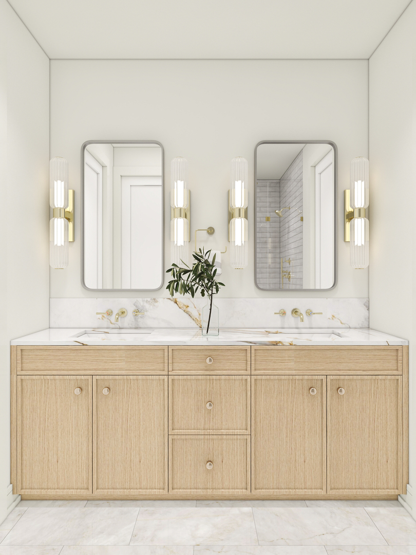 Bathroom with double-sink light wood vanity, marble surfaces, brass fixtures, and twin mirrors.