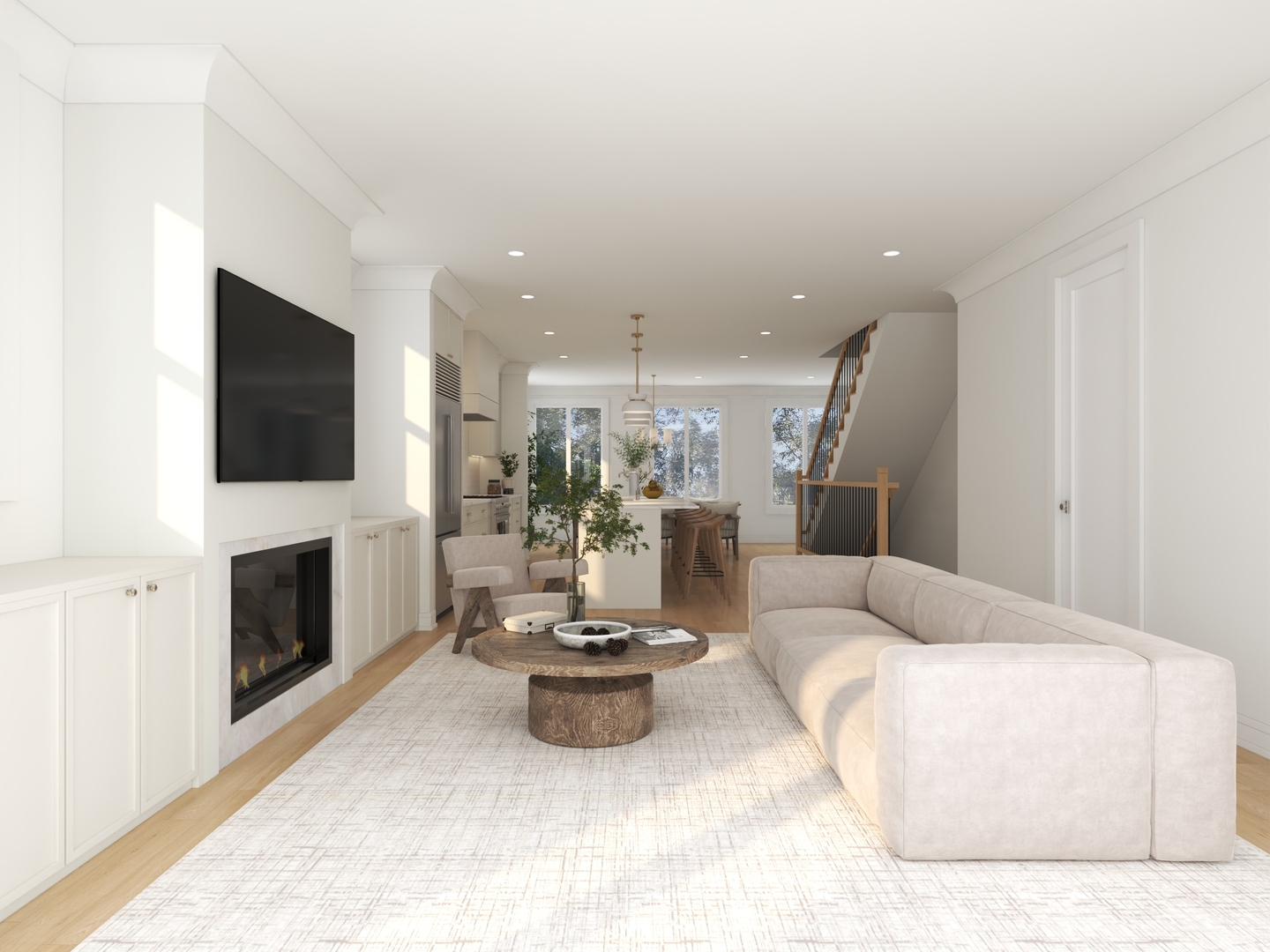 Living room with a sectional sofa, fireplace, wall-mounted TV, and open kitchen beyond.