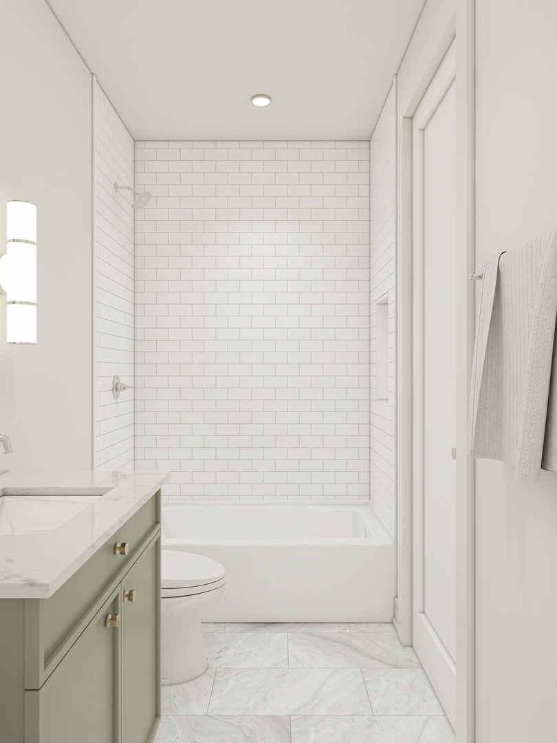 Modern bathroom with a subway-tile shower, sage green vanity, and marble-look floor.