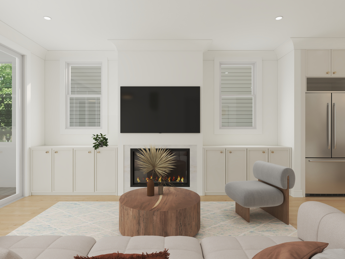 Staged living room with a fireplace, wall-mounted television, built-ins, and a round wood coffee table.
