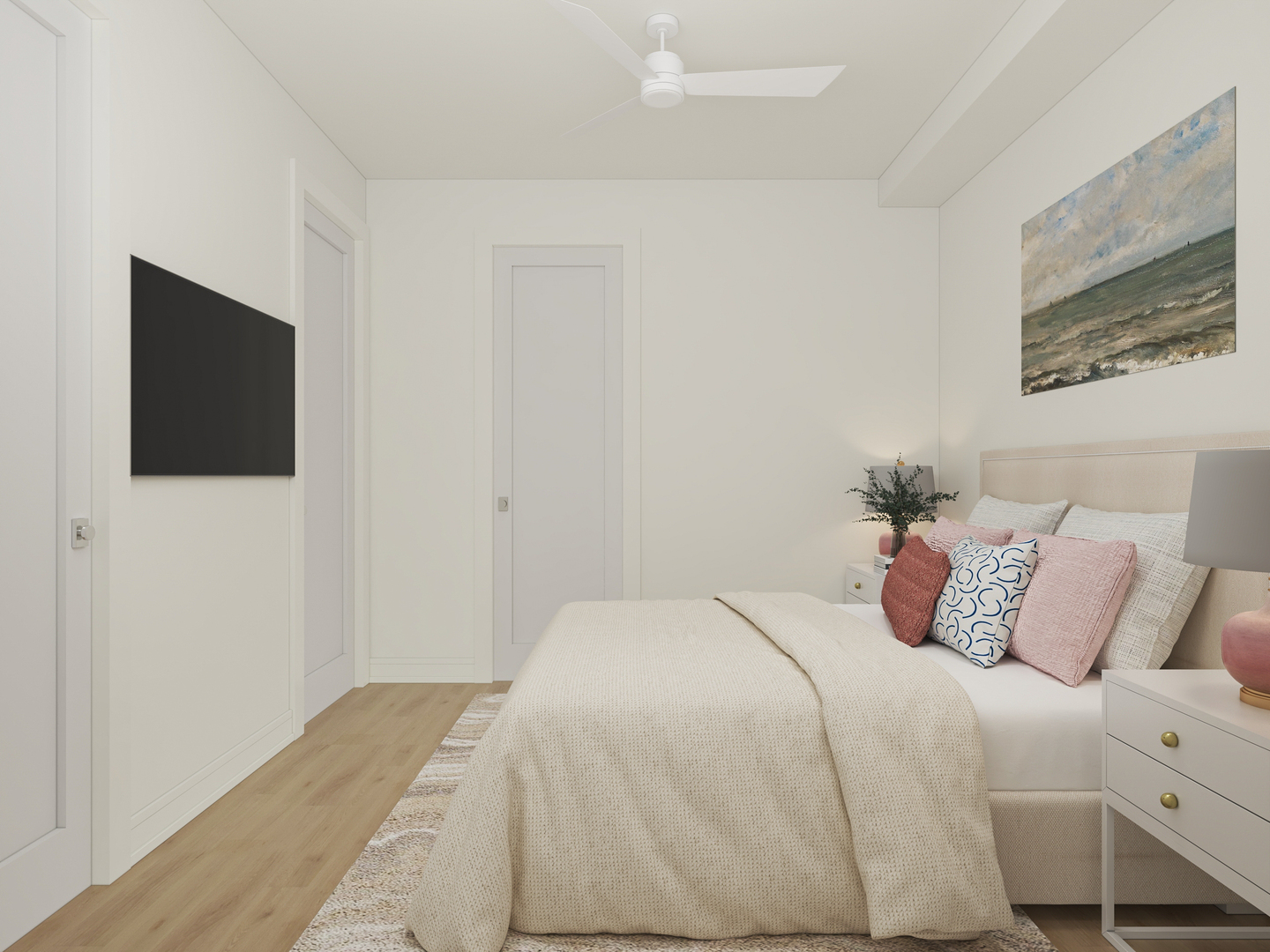 Staged bedroom with a cream upholstered bed, pink accent pillows, ceiling fan, and wall-mounted television.
