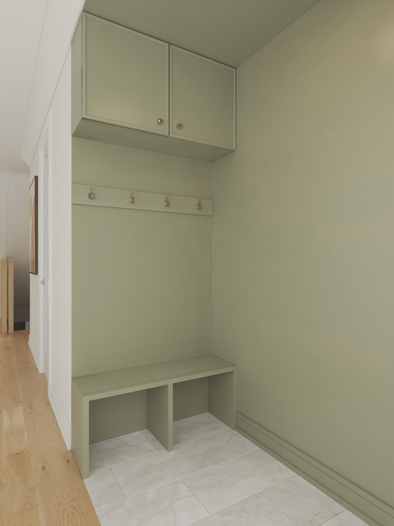 Sage-green entryway with built-in bench, shoe cubbies, wall hooks, and overhead cabinets.