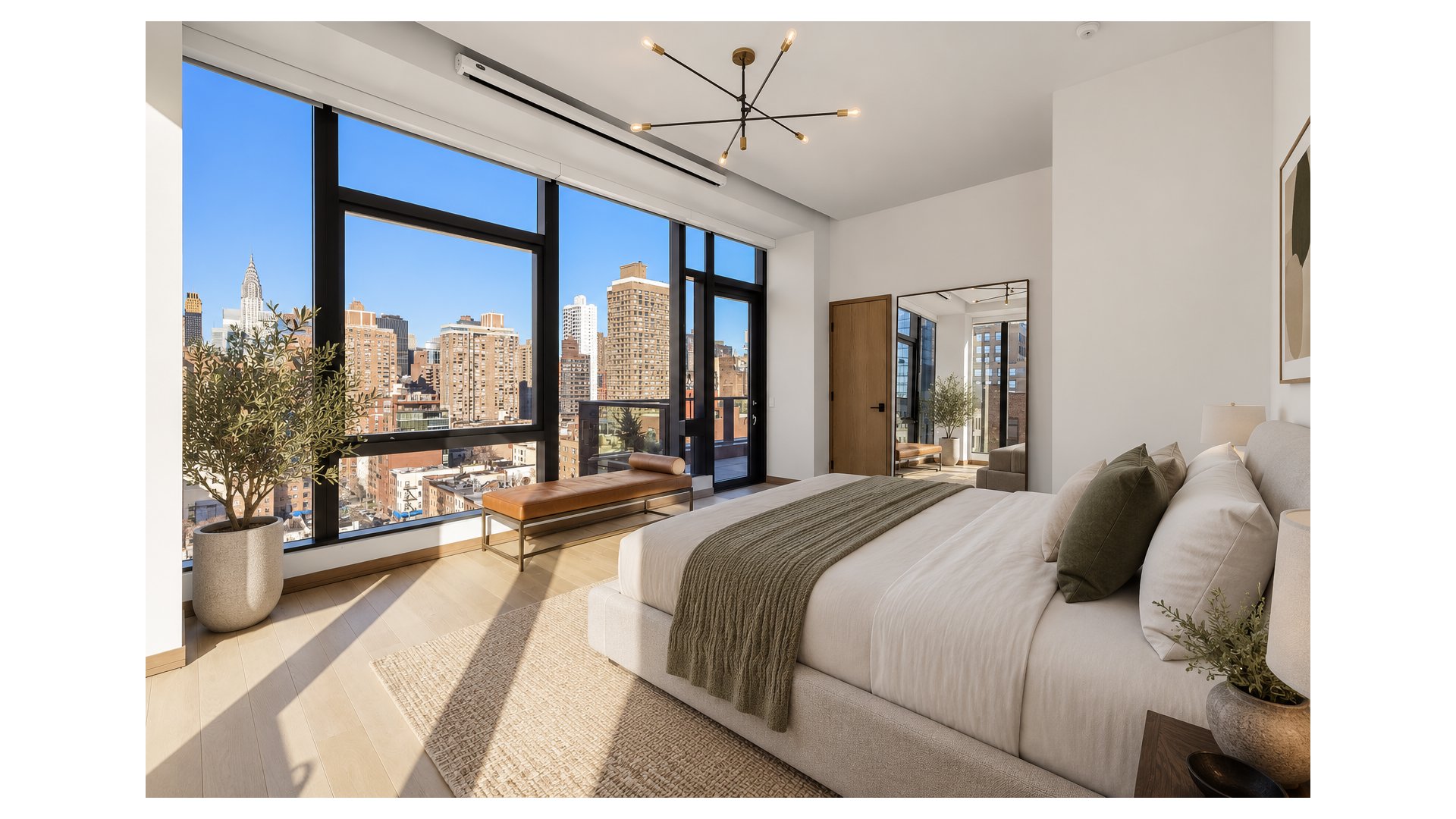 Furnished bedroom with floor-to-ceiling city-view windows, a white bed, and a modern chandelier.