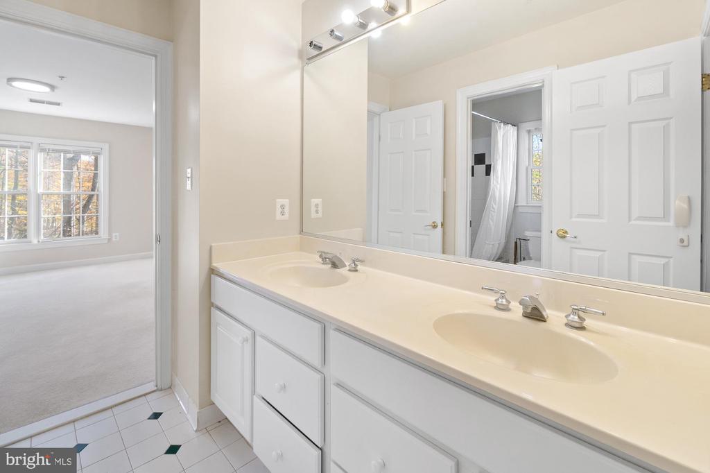 Bathroom with a long double-sink vanity and large mirror.