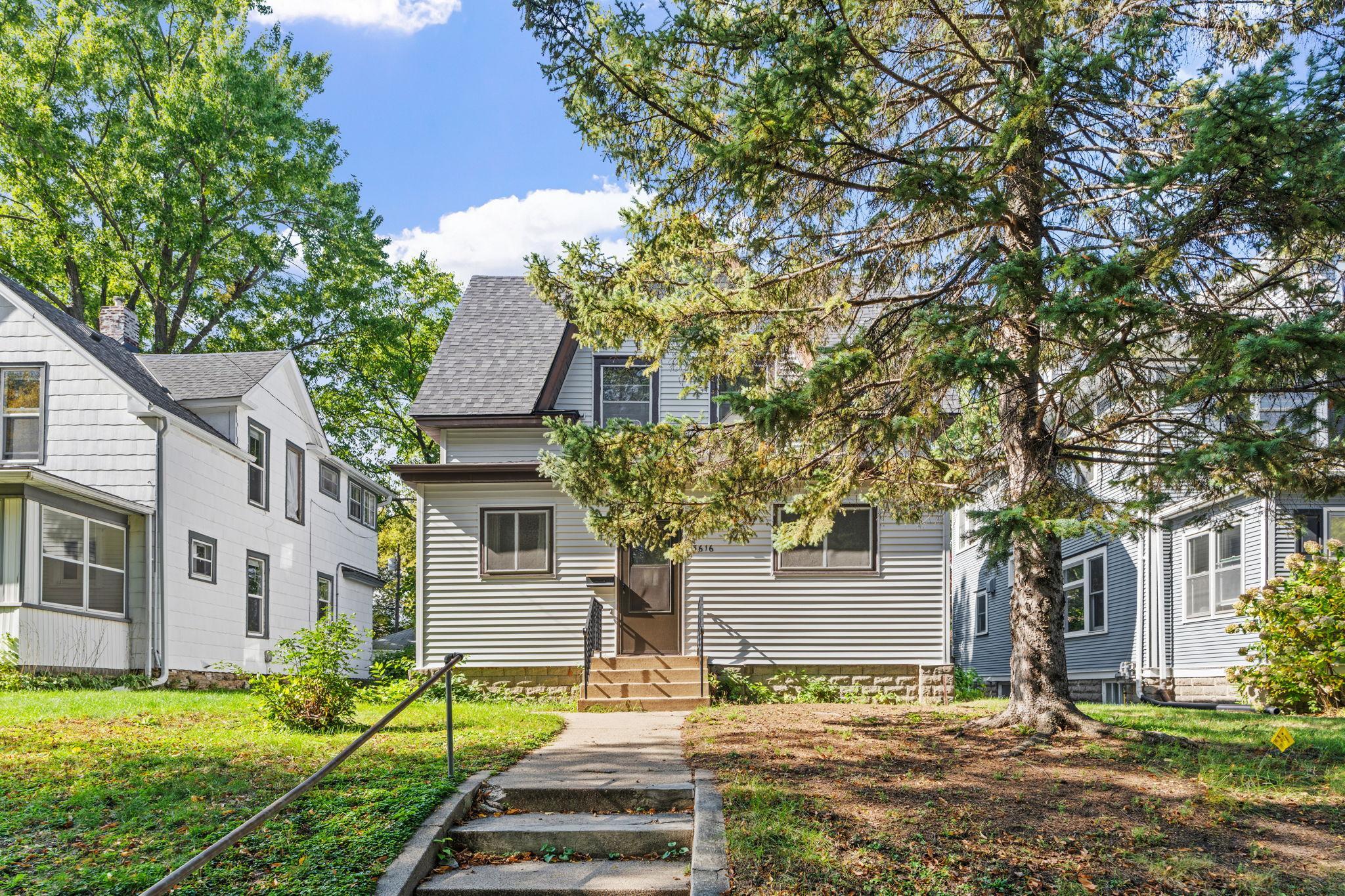 3616 Pillsbury Avenue S, a two-story house partly shaded by a large evergreen tree.