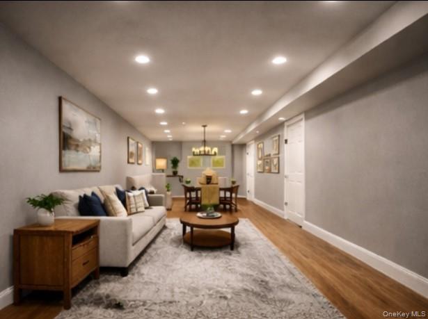 Staged living room with a light sofa, wood coffee table, and dining area.