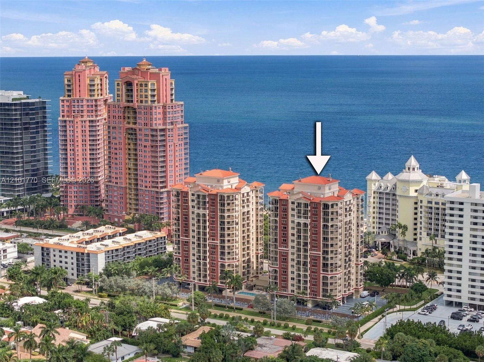 Fort Lauderdale oceanfront high-rises beside the Atlantic, with an arrow pointing to a condominium building.