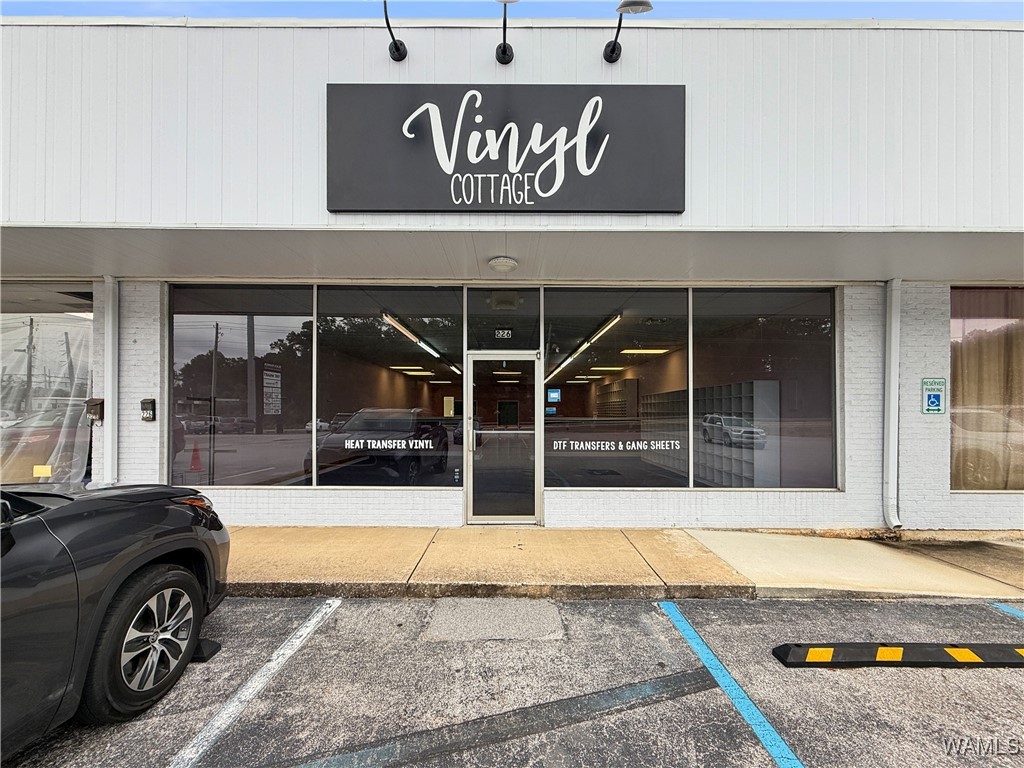 Retail storefront with Vinyl Cottage sign and glass entrance marked 226.