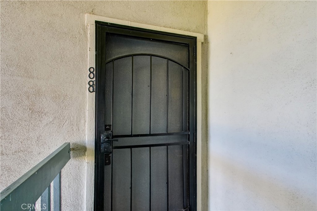 Home entrance with a black metal security door and unit number 88.