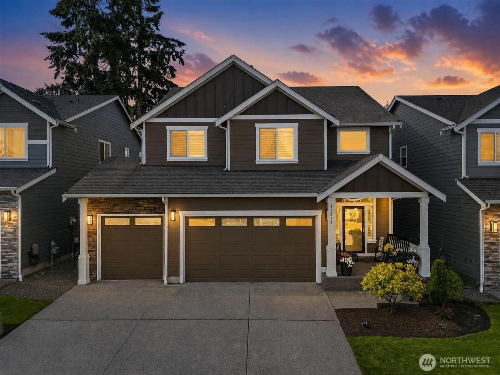 Home at 10626 130th Street E with a double garage and illuminated windows at dusk.