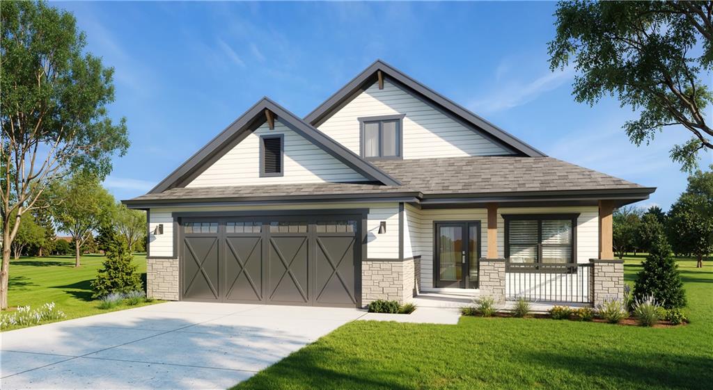 Suburban home with a double garage, stone veneer, and a covered entry.