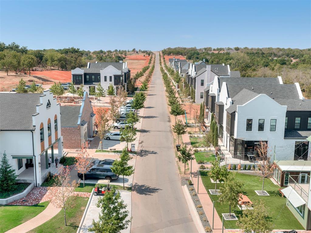 Aerial view of a residential street lined with modern homes and landscaped yards.