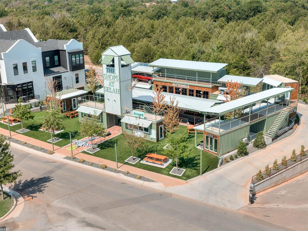 The Shops at Selah retail complex with outdoor seating and a central tower sign.