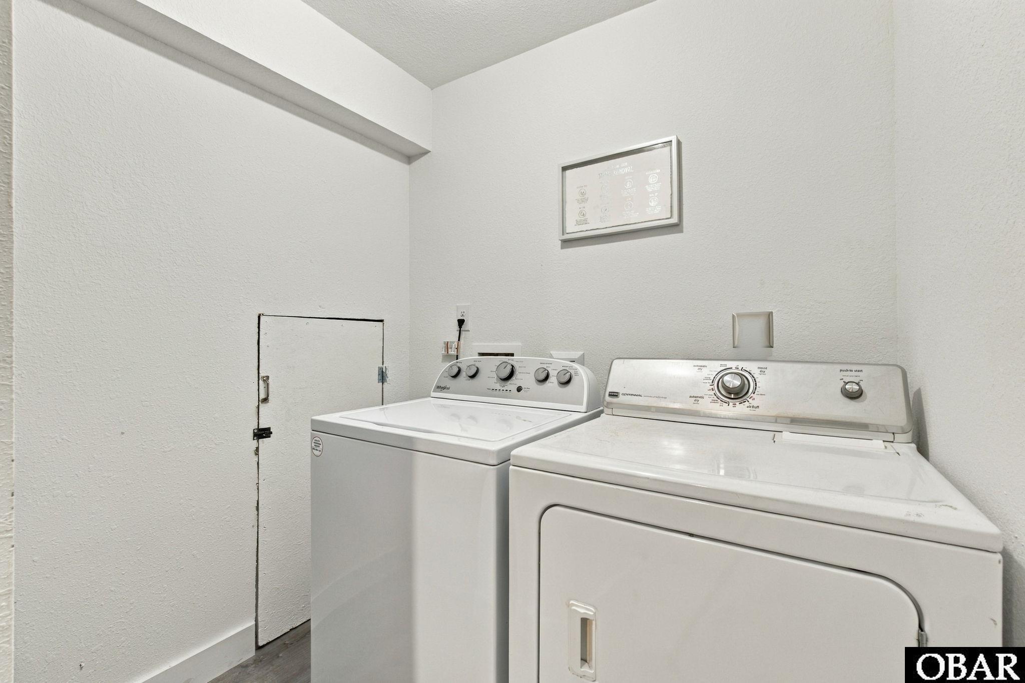 Laundry room with a white washer and matching front-loading dryer.