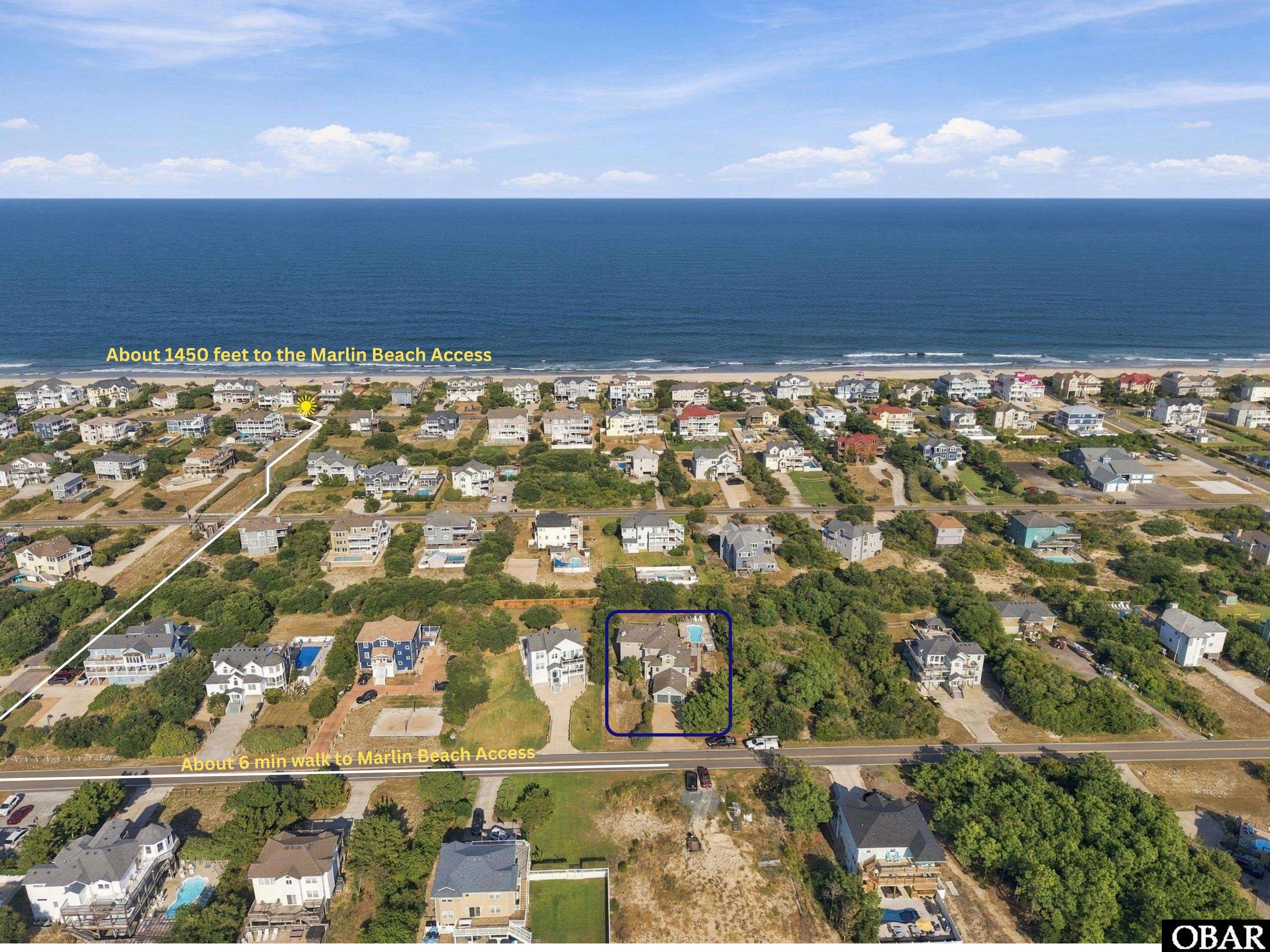 Aerial view of a highlighted home in a coastal neighborhood near the ocean and Marlin Beach Access.