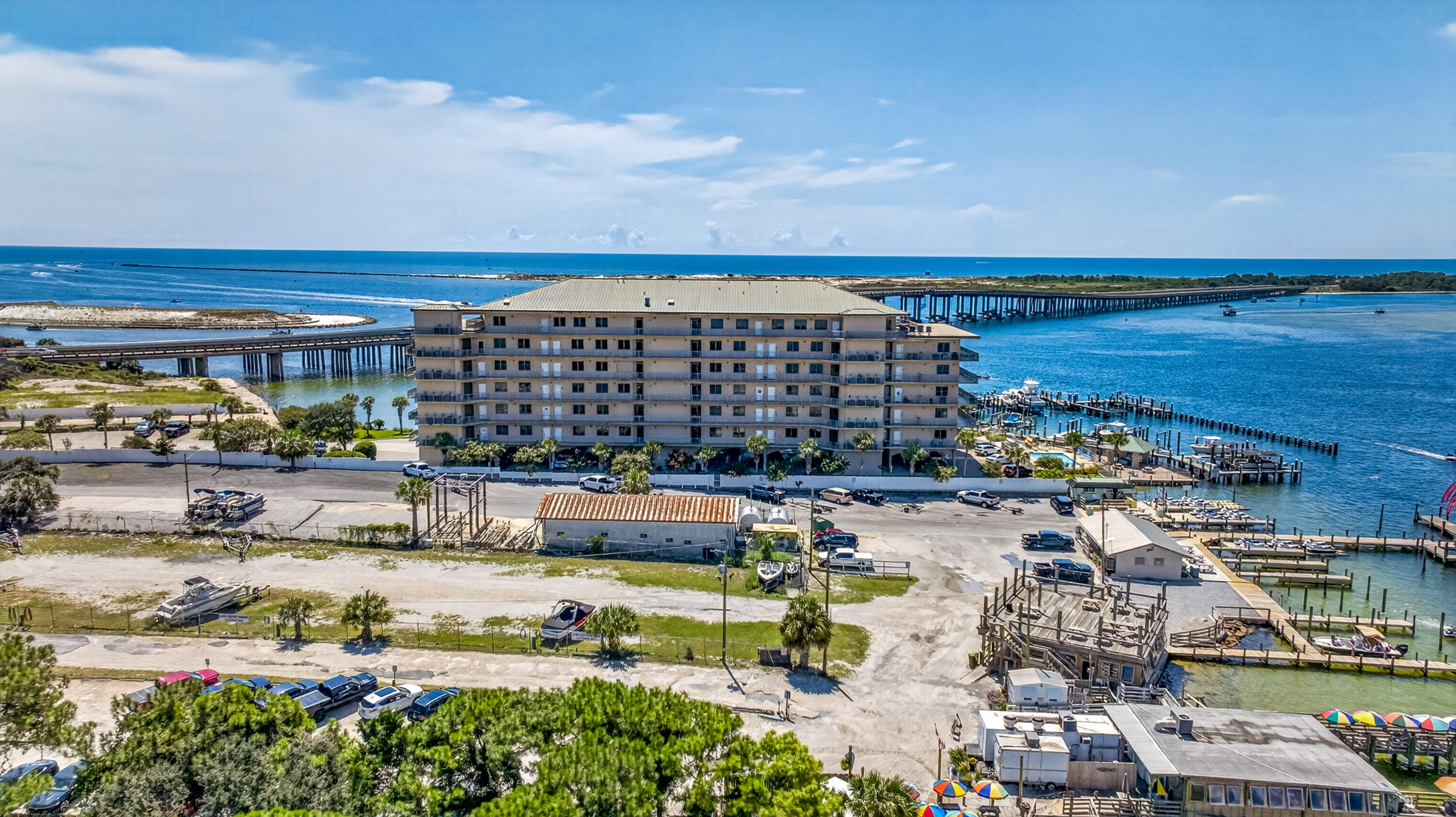 Waterfront condominium with marina docks and bridges across the bay.