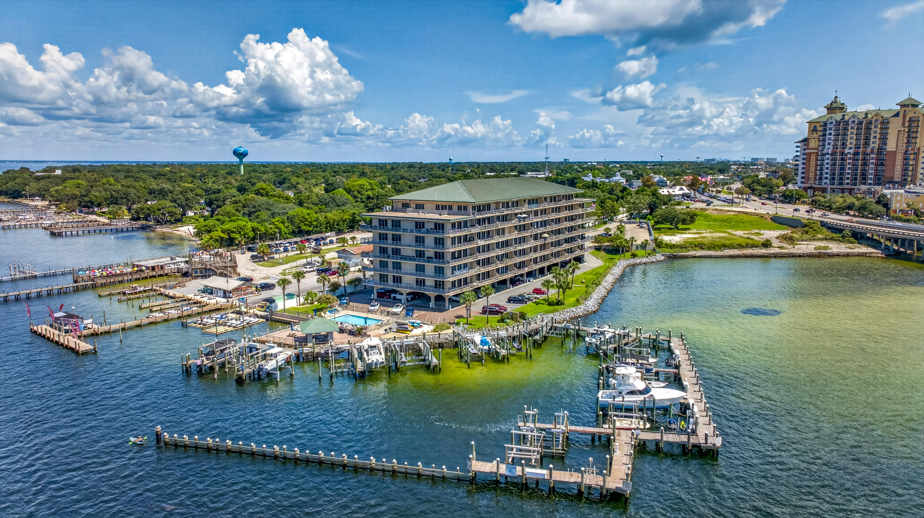 Waterfront condominium surrounded by marina docks and boats in Destin.