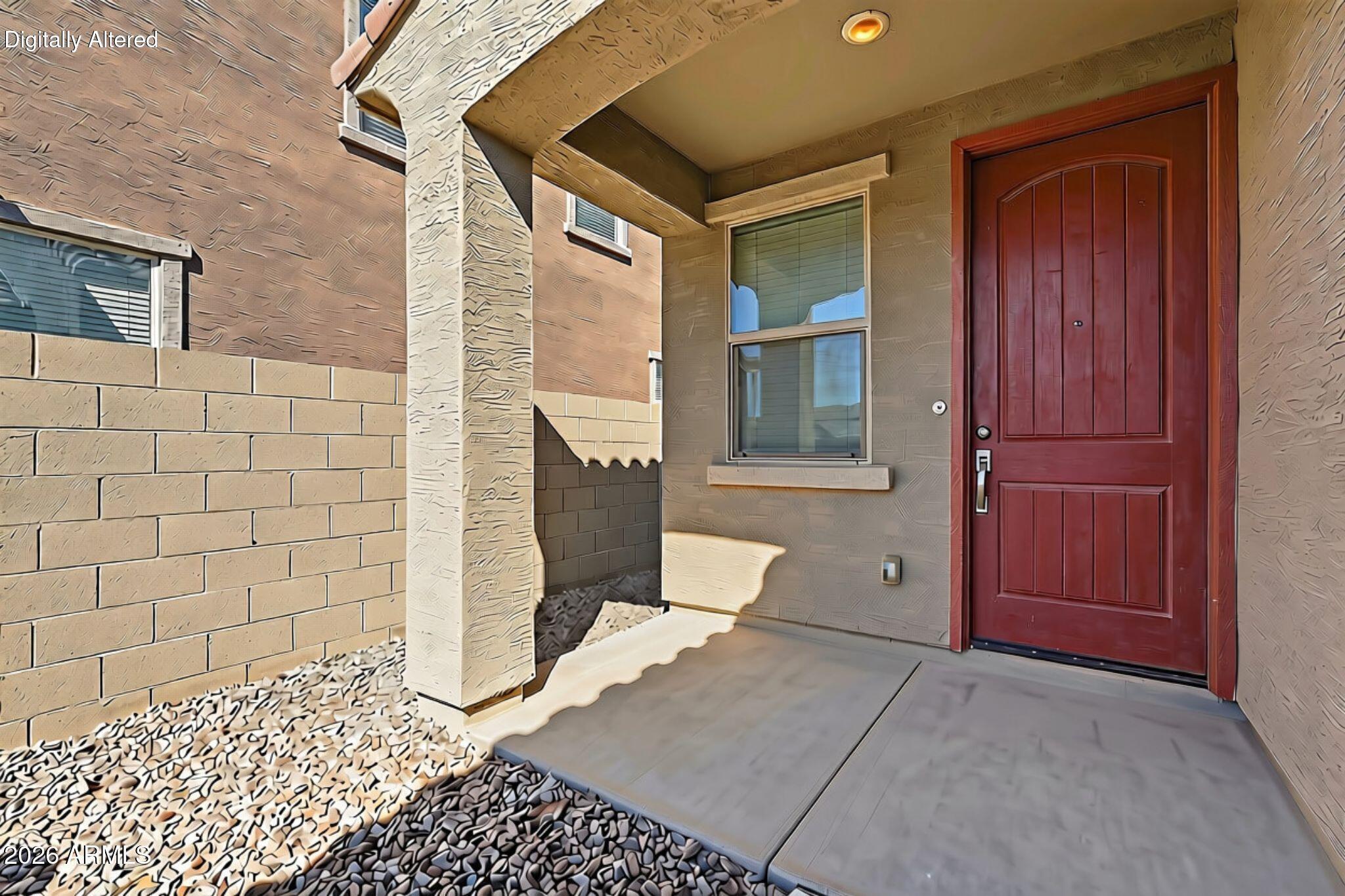 Covered front porch with a red paneled door, window, and decorative gravel landscaping.