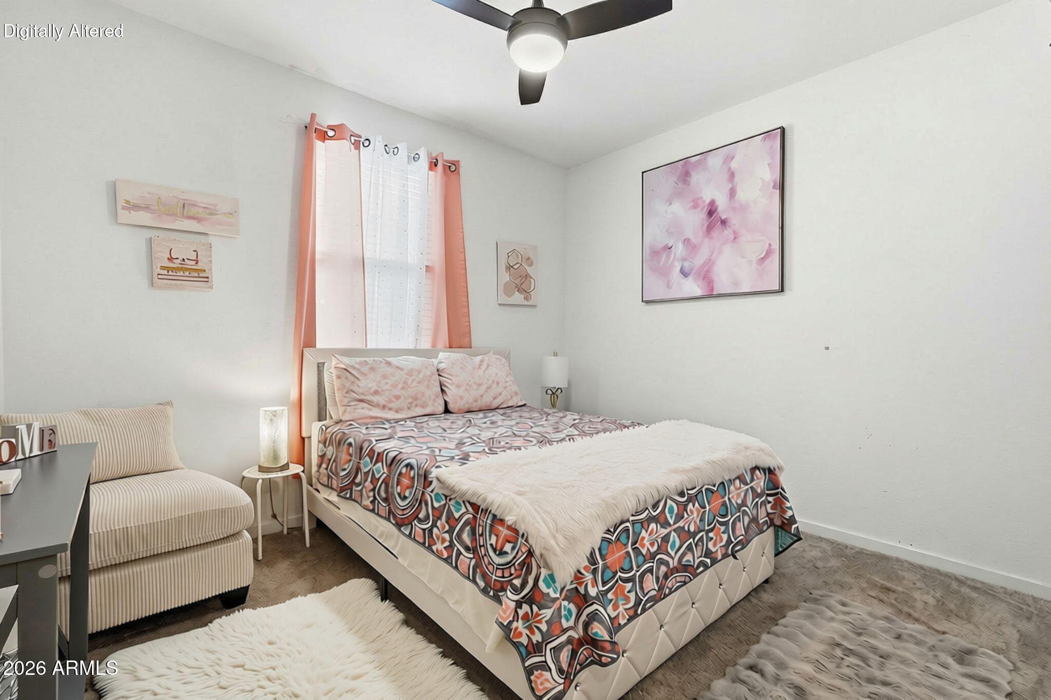 Furnished bedroom with a colorful patterned bedspread, white throw, and striped armchair.