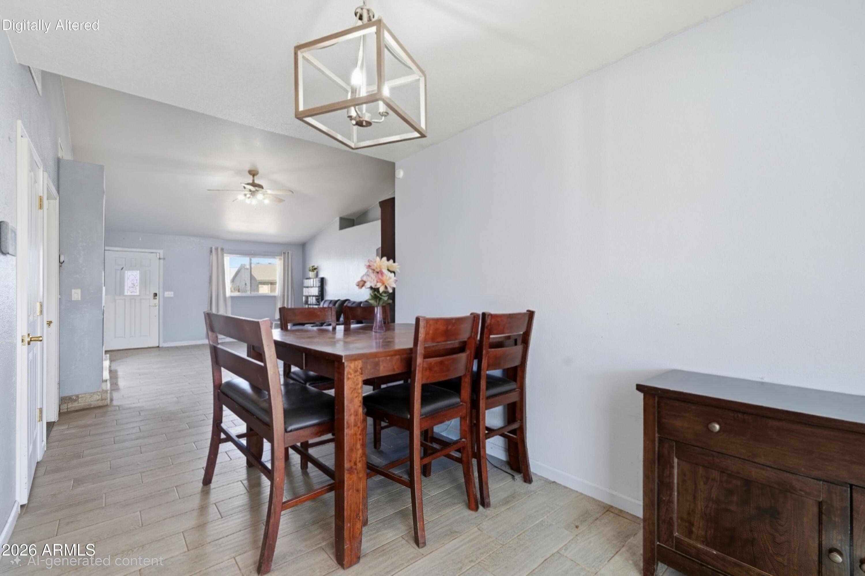 Dining room with a dark wood table and chairs, geometric pendant light, and tile flooring.