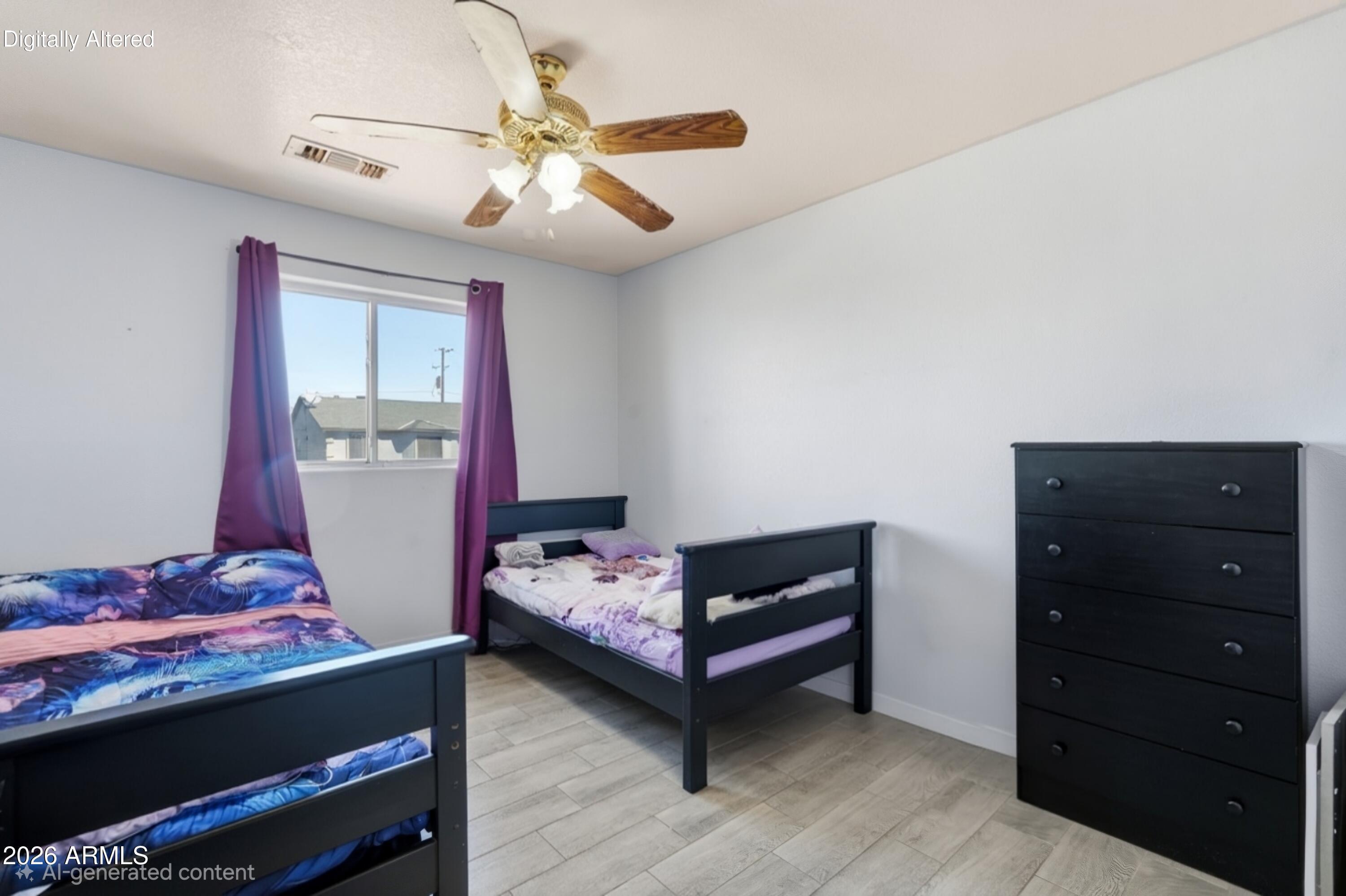 Bedroom with two twin beds, purple curtains, a black dresser, and a ceiling fan.